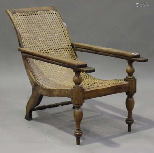 A 20th century hardwood plantation style chair with cane seat and back, on turned legs, height