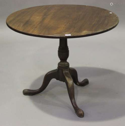 A George III mahogany tip-top circular supper table, raised on a turned column and tripod cabriole
