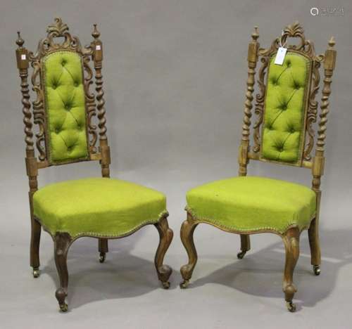 A pair of late Victorian walnut framed side chairs with carved decoration, the overstuffed seats