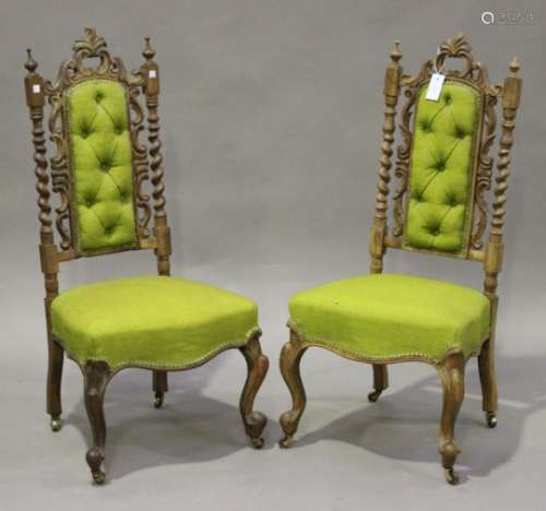 A pair of late Victorian walnut framed side chairs with carved decoration, the overstuffed seats