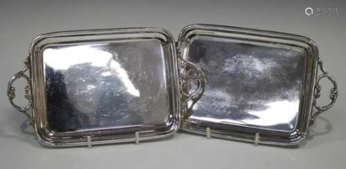 A pair of early 20th century Polish plated rectangular trays, each flanked by a pair of scroll