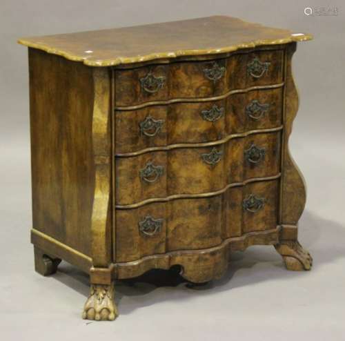 An 18th century and later Dutch walnut commode chest of four graduated long drawers, on claw and