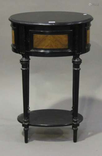 A 19th century ebonized and kingwood oval table, fitted with a cupboard, on fluted legs, height