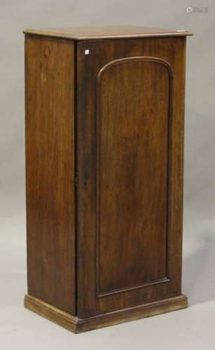 A Victorian mahogany side cabinet, the arched panel door revealing drawers, on a plinth base, height