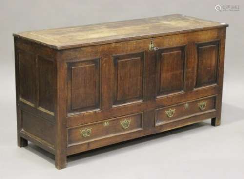An 18th century oak mule chest, the hinged top above a panelled front and two drawers, on bracket