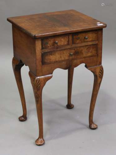 A late 19th century French walnut side table, fitted with three drawers, raised on carved cabriole