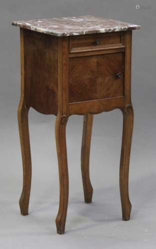 An early 20th century walnut bedside cabinet, the rouge marble top above a drawer and cupboard, on