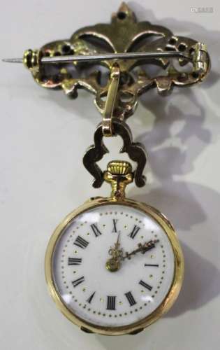 A gold, diamond and ruby dress pendant brooch watch with jewelled movement, the white enamelled dial