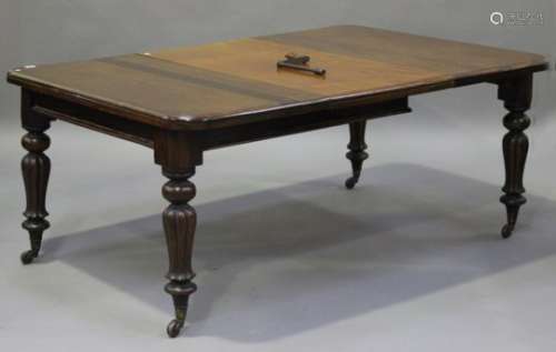 A Victorian mahogany extending dining table, the top with a moulded edge and a single extra leaf, on