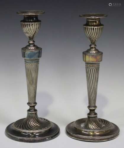 A pair of Victorian silver candlesticks with detachable nozzles, on spiral fluted columns and