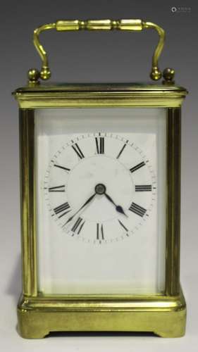 An early 20th century lacquered brass carriage timepiece with eight day movement, the corniche