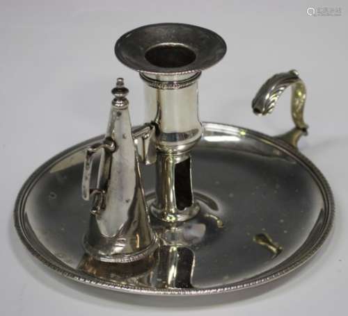 A George III silver chamberstick with detachable nozzle and conical snuffer, the thumbpiece of