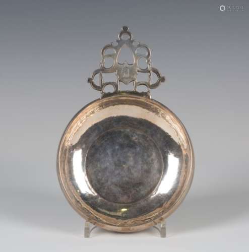 A William III Britannia silver bleeding bowl of circular form, the flat tab handle with pierced