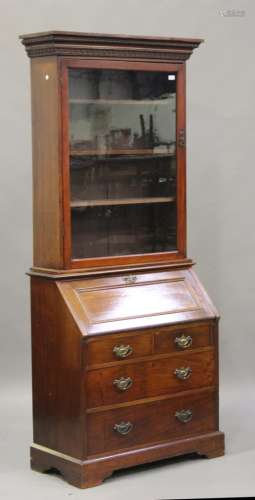 An Edwardian mahogany bureau with a matched walnut glazed bookcase top, the moulded pediment above a