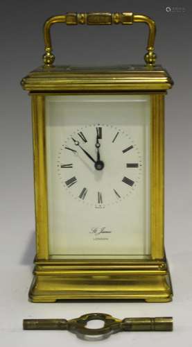 A late 20th century brass cased carriage timepiece with eight day movement, the enamel dial with