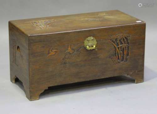 A 20th century Chinese camphor trunk with carved decoration, raised on bracket feet, height 49cm,