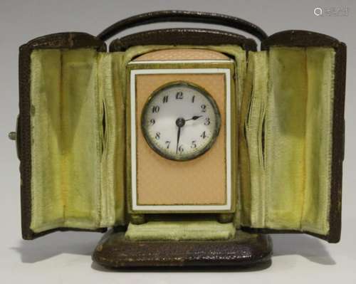 An early 20th century gilt metal and enamelled miniature bedside timepiece, the enamel dial with