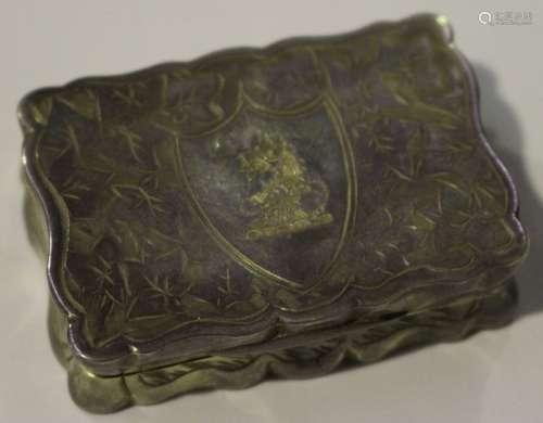 A late Victorian silver shaped rectangular vinaigrette engraved with a shield and crest amongst