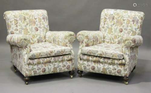 A pair of George V armchairs, on bun feet and castors, height 86cm, width 81cm.Buyer’s Premium 29.4%