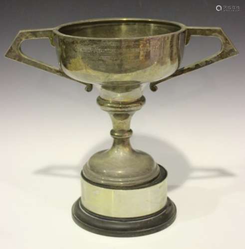 A large Elizabeth II two-handled silver trophy cup, the ogee bowl flanked by angular handles, raised
