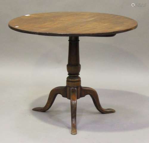 A George III mahogany circular tip-top supper table, raised on a turned column and tripod cabriole
