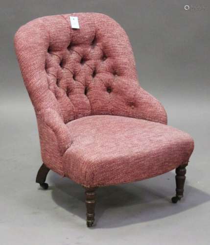 A Victorian nursing chair, upholstered in red fabric, on turned legs and brass castors, height 72cm,