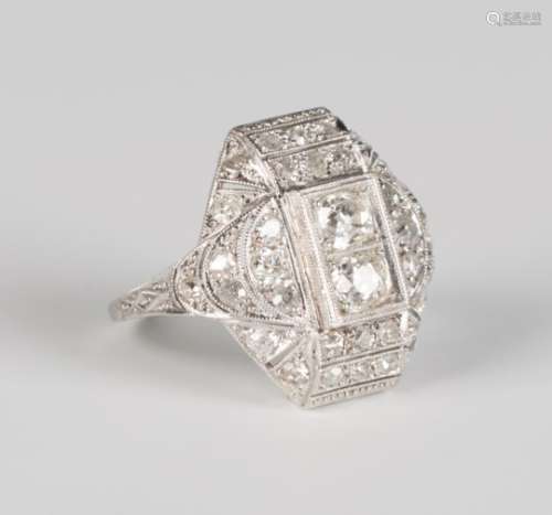 A platinum and diamond ring, mounted with two principal circular cut diamonds within a shaped