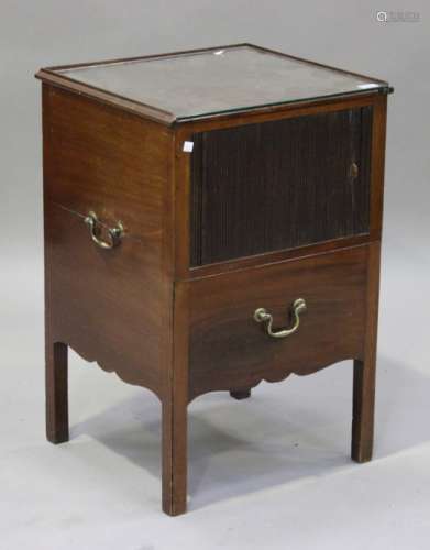 A George III mahogany bedside cabinet, fitted with brass carrying handles, the tambour front above a