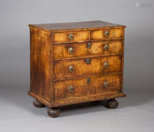 A Queen Anne walnut chest of two short and three long drawers, with overall crossbanded and