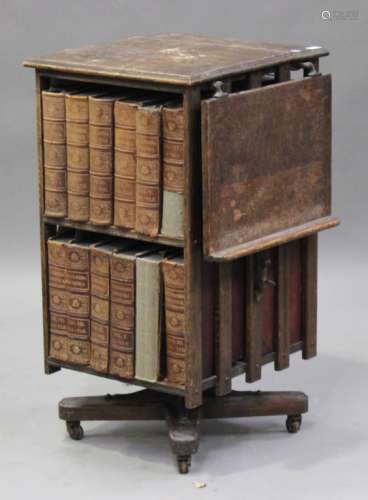 A George V oak revolving bookcase, one side with hinged reading slope, height 92cm, width 54cm,