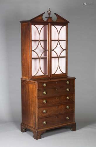 A George III mahogany secrétaire bookcase cabinet of small proportions, the swan neck and central