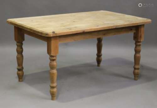 A late 20th century pine kitchen table, the rectangular top raised on turned legs, height 79cm,