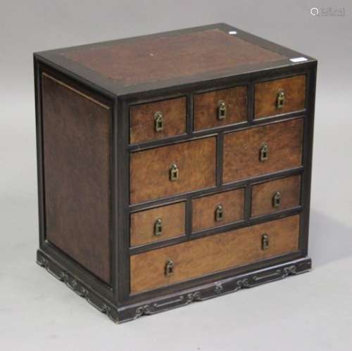 A late 20th century Chinese hardwood chest, fitted with nine drawers, on a plinth base with
