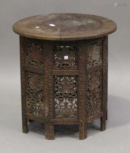 A late 19th/early 20th century Indian hardwood circular folding occasional table with profusely