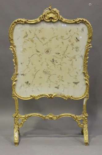 A 19th century Rococo Revival giltwood and gesso framed firescreen, inset with a silkwork panel,