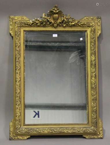 A late 19th century giltwood and gesso framed pier mirror with foliate scroll surmount, 120cm x