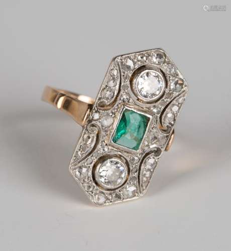 An emerald and diamond ring in an elongated hexagonal design, mounted with a rectangular emerald and