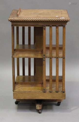 A late 19th century American oak revolving bookcase by Danner, the top fitted with a hinged