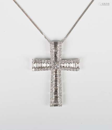 An 18ct white gold and diamond pendant cross, claw set with the principal circular cut diamond to