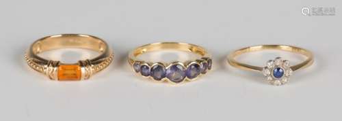 A gold, sapphire and diamond nine stone cluster ring, detailed '18ct', an 18ct gold and mauve gem