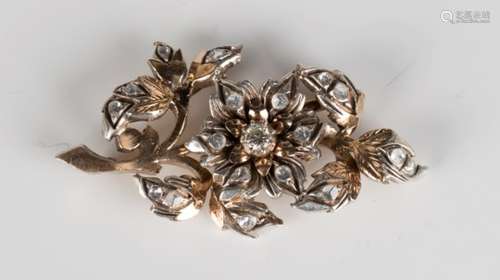 A gold, silver and diamond brooch in a floral design, mounted with the principal circular cut