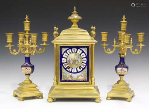 A late 19th century French ormolu and porcelain clock garniture, the mantel clock with eight day