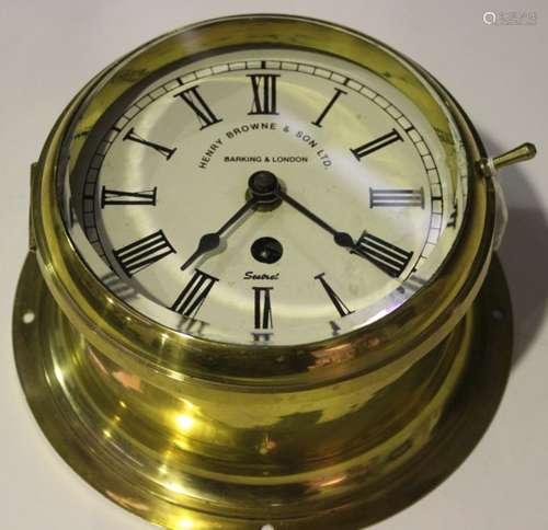 A 20th century brass circular cased ship's timepiece, the dial with black Roman numerals and