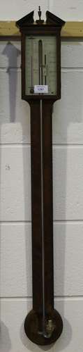 An early 19th century mahogany stick barometer, the silvered rectangular dial with vernier scale,