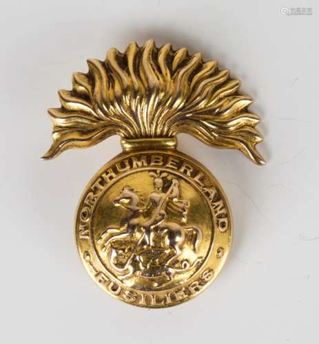 A First World War period 9ct gold military brooch, designed as the cap badge of the Northumberland