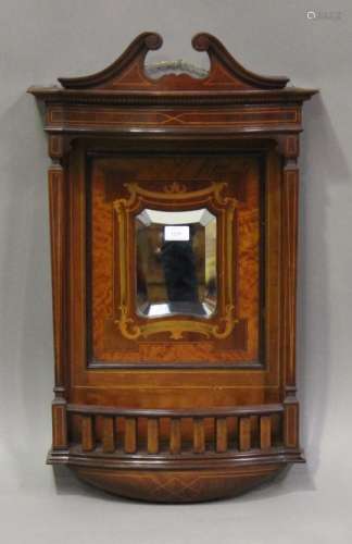 An Edwardian mahogany and foliate inlaid hall mirror, the swan neck pediment raised on square