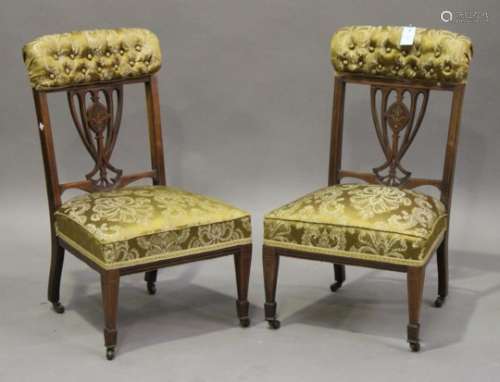 A pair of Edwardian mahogany and foliate inlaid side chairs, the overstuffed seats raised on