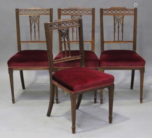 A set of four Edwardian mahogany salon chairs, the overstuffed seats raised on square tapering legs,