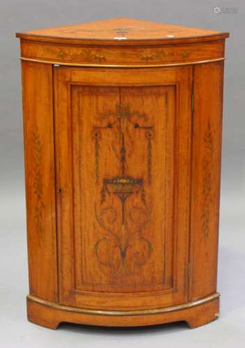 An Edwardian Neoclassical Revival satinwood bowfront corner cabinet with inlaid decoration, fitted