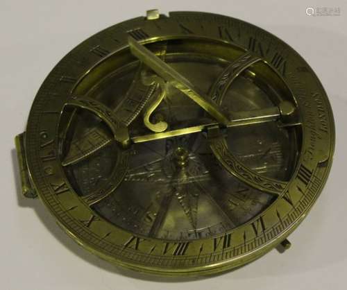 A late 19th century brass compass sundial by Troughton & Simms London, the silvered circular dial